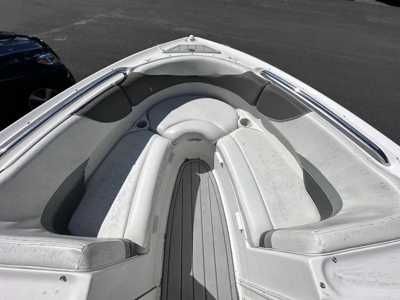 Slide: The Image of 2006 Yamaha Boats SX 230 bow seating area with white and gray upholstery. - 28