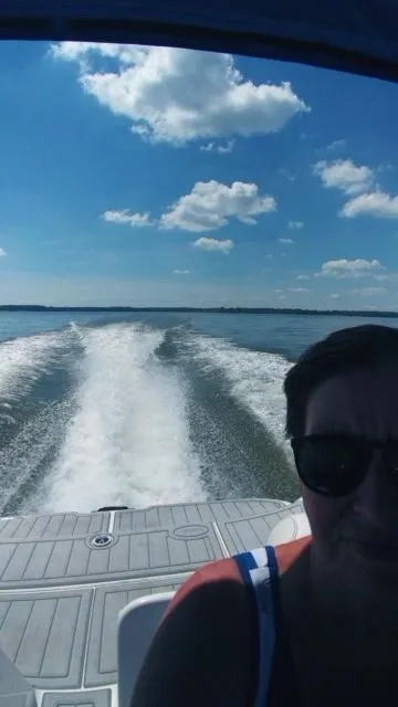 Slide: The Image of 2006 Yamaha SX 230 boat cruising on a sunny day with a clear blue sky. - 29