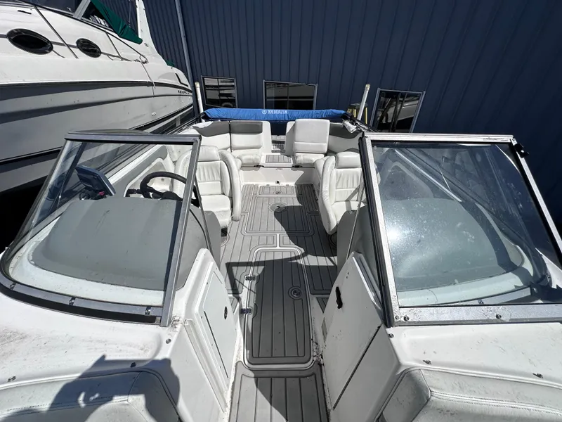 Slide: The Image of 2006 Yamaha Boats SX 230 interior view with white seating and steering console. - 31