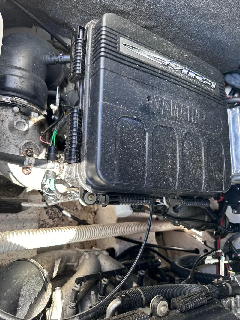 Slide: The Image of 2006 Yamaha Boats SX 230 engine compartment showing fuel injection system and various components. - 32