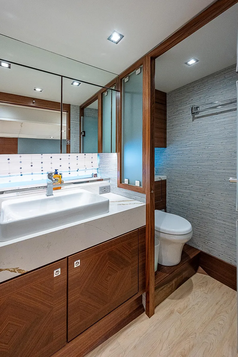 Slide: The Image of Luxurious bathroom in 2022 Summit 54 Motoryacht with modern fixtures and wood accents. - 49