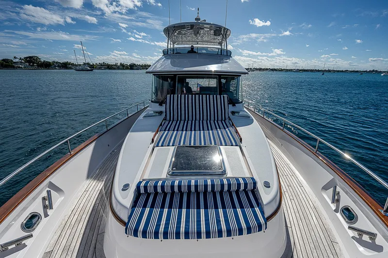 Slide: The Image of 2022 Summit 54 Motoryacht with striped deck cushions on open water. - 7