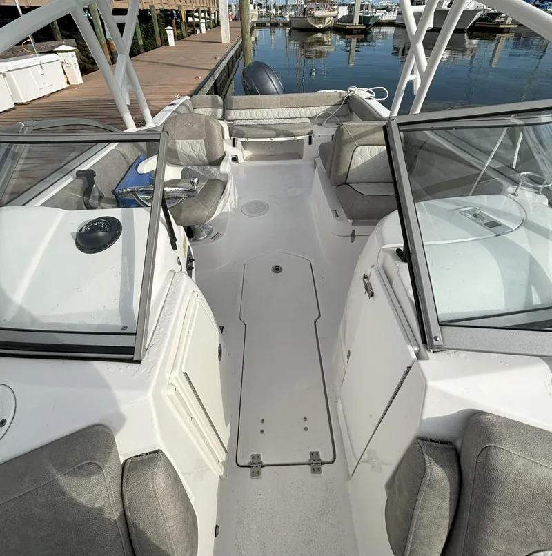 Slide: The Image of 2023 Sea Fox 226 Traveler boat interior with seating and console, docked at marina. - 4