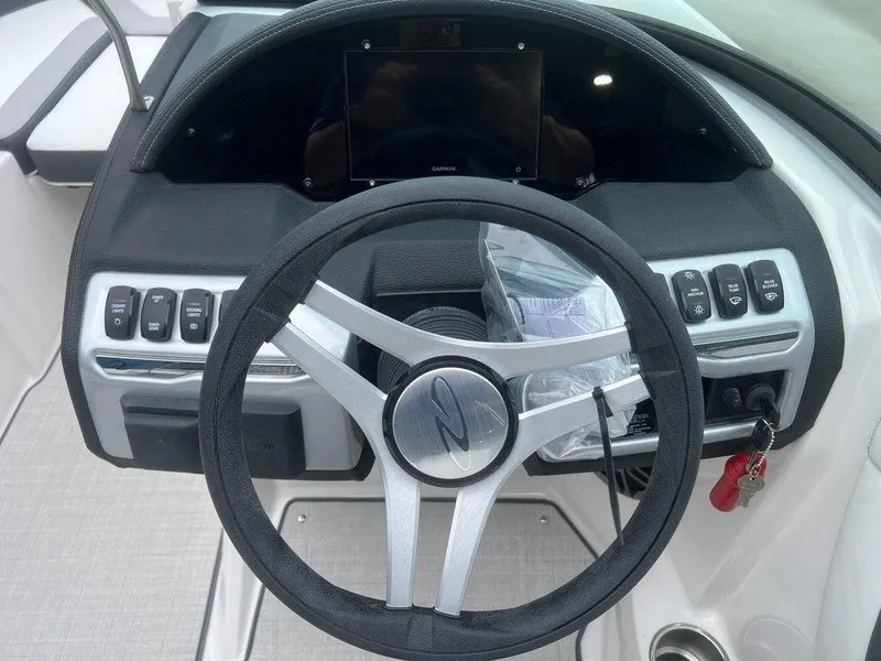 Slide: The Image of 2024 Regal 2000 ES boat dashboard with steering wheel and control panel. - 10