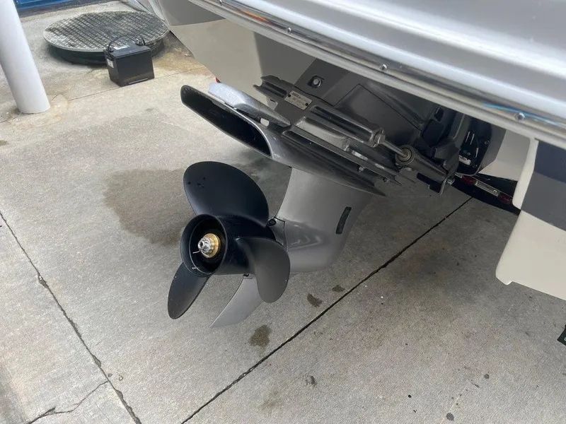 Slide: The Image of Close-up of a 2024 Regal 2000 ES boat propeller and outboard motor. - 14