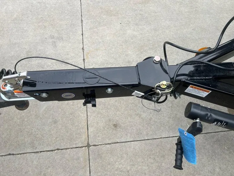 Slide: The Image of 2024 Regal 2000 ES trailer hitch and coupler on concrete surface. - 17