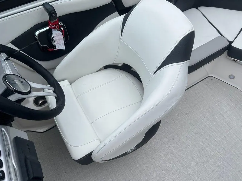 Slide: The Image of Captain's seat of a 2024 Regal 2000 ES boat with white and black upholstery. - 7