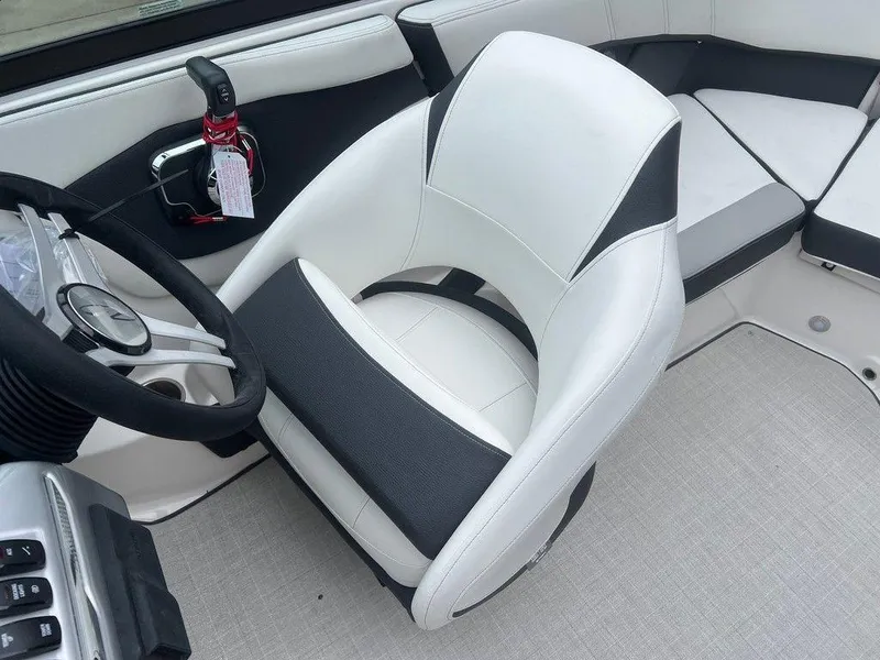 Slide: The Image of 2024 Regal 2000 ES boat interior with white and black captain's chair. - 9