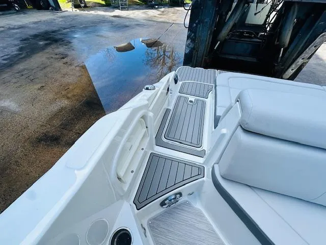 Slide: The Image of 2024 Sea Ray 270 SDX boat deck with cushioned seating and storage compartments. - 13