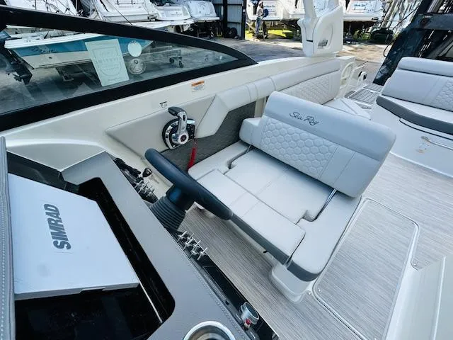 Slide: The Image of 2024 Sea Ray 270 SDX boat interior with steering wheel and seating. - 18