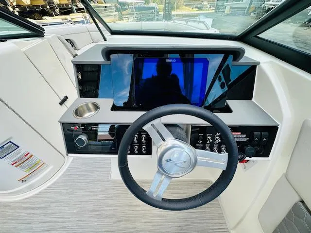 Slide: The Image of 2024 Sea Ray 270 SDX boat dashboard with steering wheel and control panel. - 20