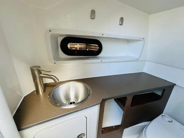 Slide: The Image of 2024 Sea Ray 270 SDX boat interior sink and countertop area. - 21