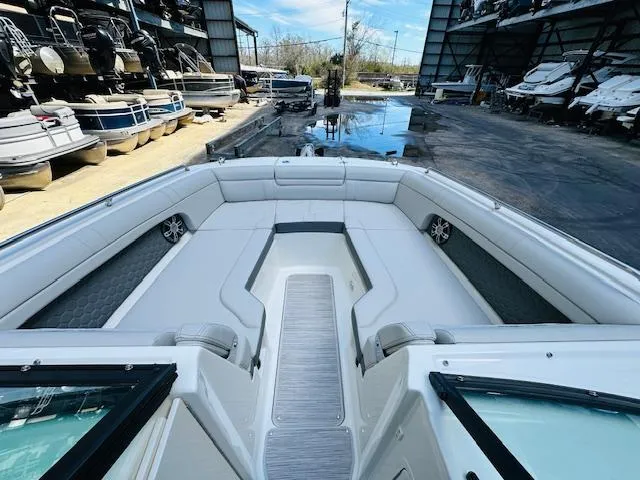 Slide: The Image of 2024 Sea Ray 270 SDX boat interior at marina, spacious seating and modern design. - 23