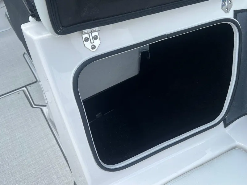 Slide: The Image of Open storage compartment on a 2024 Regal 2000 ES boat. - 10