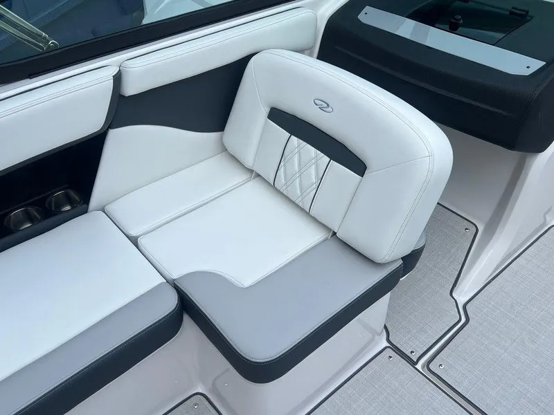 Slide: The Image of 2024 Regal 2000 ES boat interior seating with white and gray upholstery. - 12
