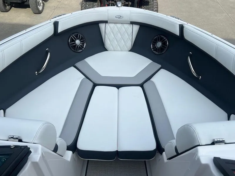 Slide: The Image of 2024 Regal 2000 ES boat interior with cushioned seating and built-in speakers. - 16