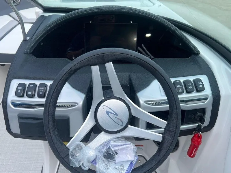 Slide: The Image of 2024 Regal 2000 ES boat steering wheel and dashboard controls. - 8