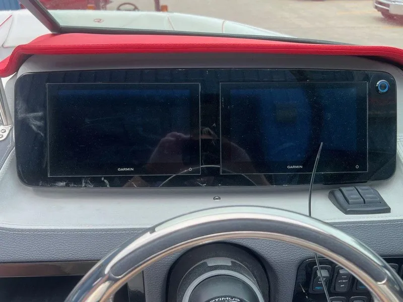 Slide: The Image of 2024 Regal LX4 dashboard with dual Garmin displays and steering wheel. - 11