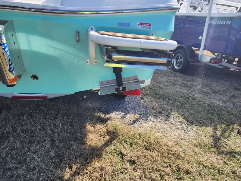 Slide: The Image of 2024 Savannah 220 IS boat rear view with ladder and trailer. - 10