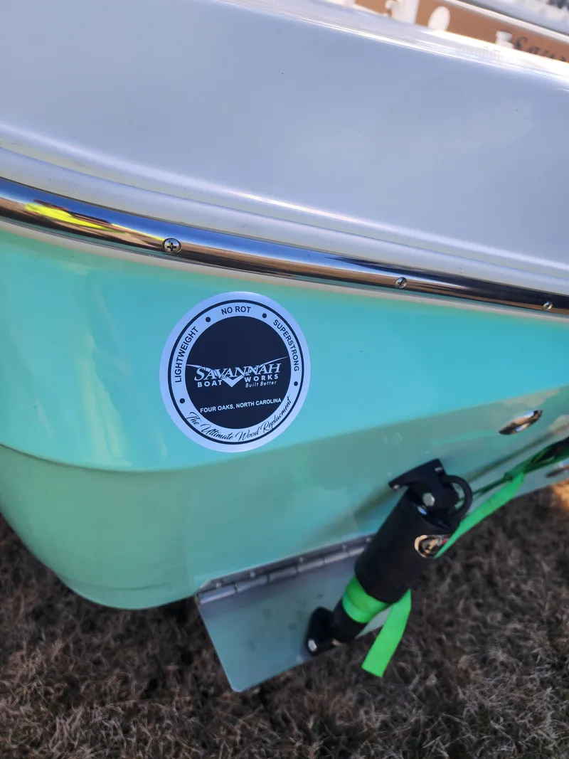Slide: The Image of 2024 Savannah 220 IS boat, close-up of the hull with logo. - 12
