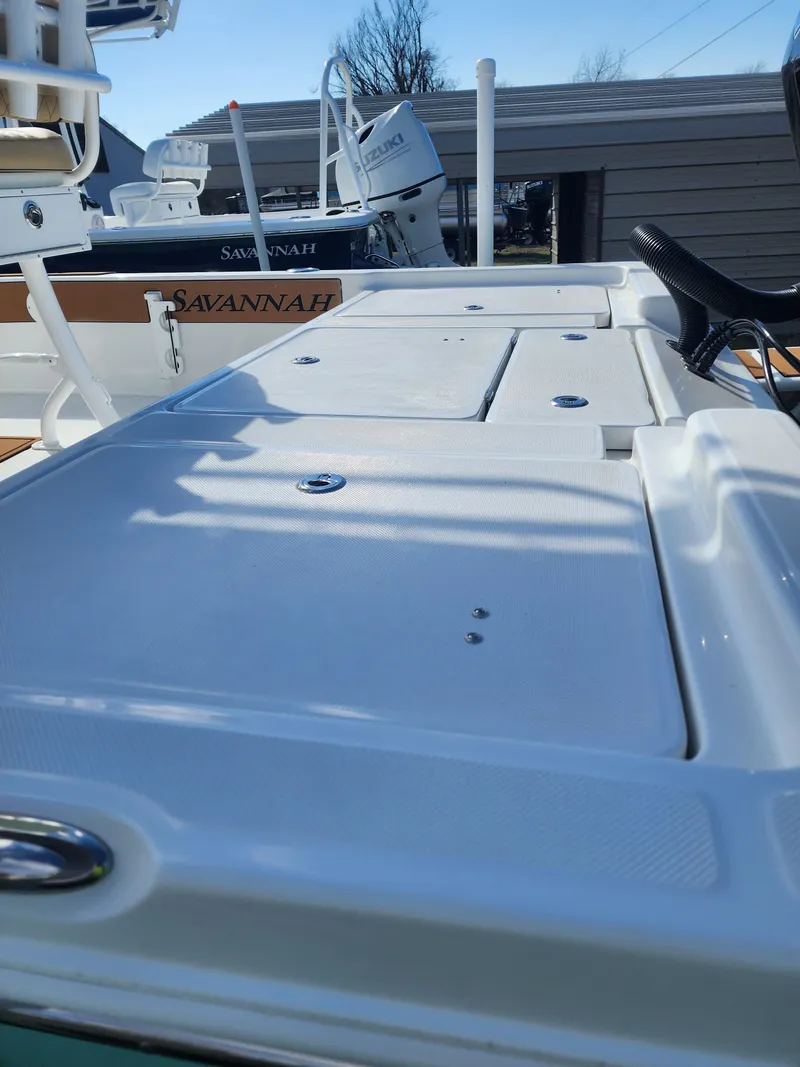 Slide: The Image of 2024 Savannah 220 IS boat deck with storage compartments. - 13
