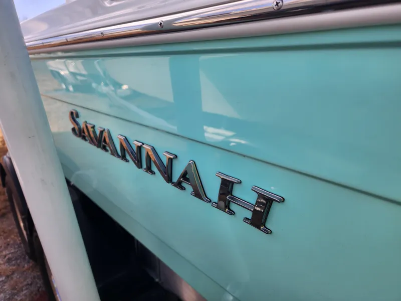 Slide: The Image of 2024 Savannah 220 IS boat side view with logo. - 14