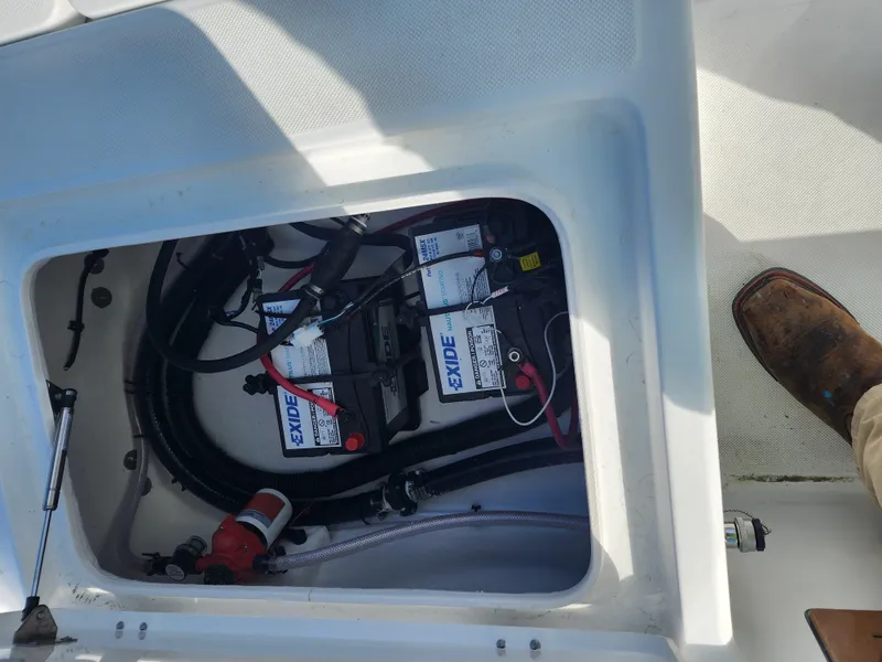Slide: The Image of Battery compartment of a 2024 Savannah 220 IS boat with Exide batteries. - 17