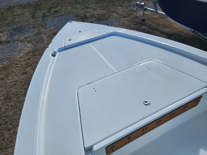 Slide: The Image of 2024 Savannah 220 IS boat deck with storage compartment. - 19