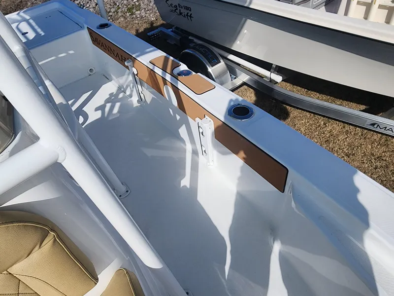 Slide: The Image of 2024 Savannah 220 IS boat interior with tan accents and cup holders. - 23
