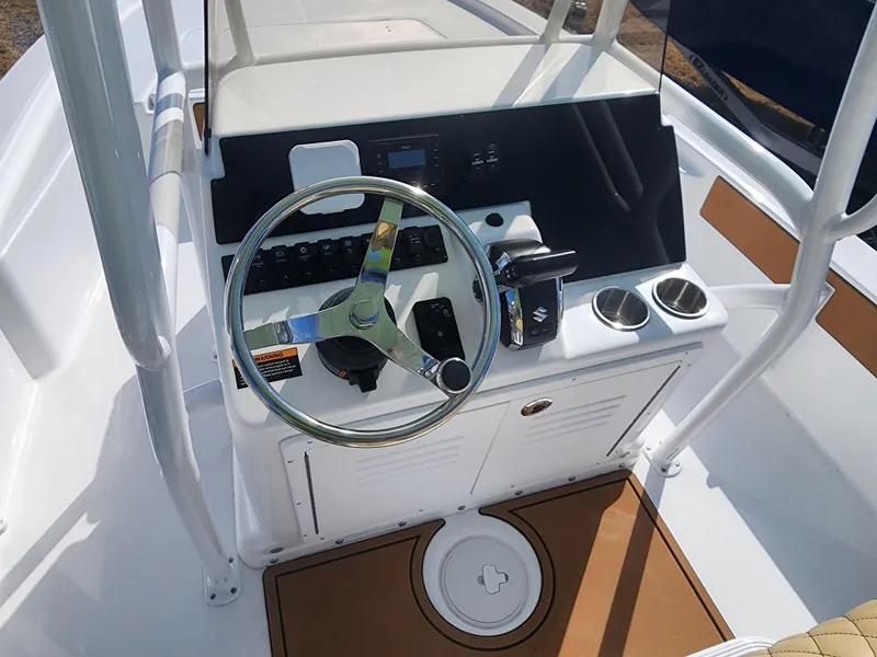Slide: The Image of 2024 Savannah 220 IS boat console with steering wheel and controls. - 26