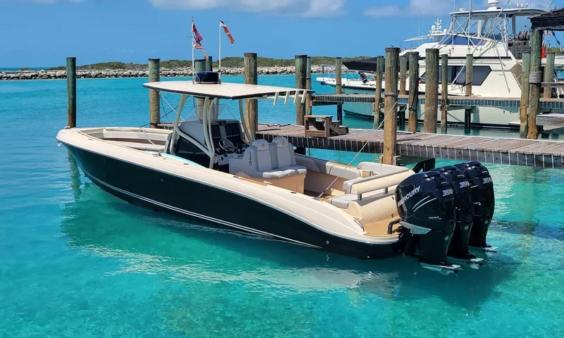 The Image of 2013 Statement 38 SUV Open boat docked in clear turquoise water. - 0