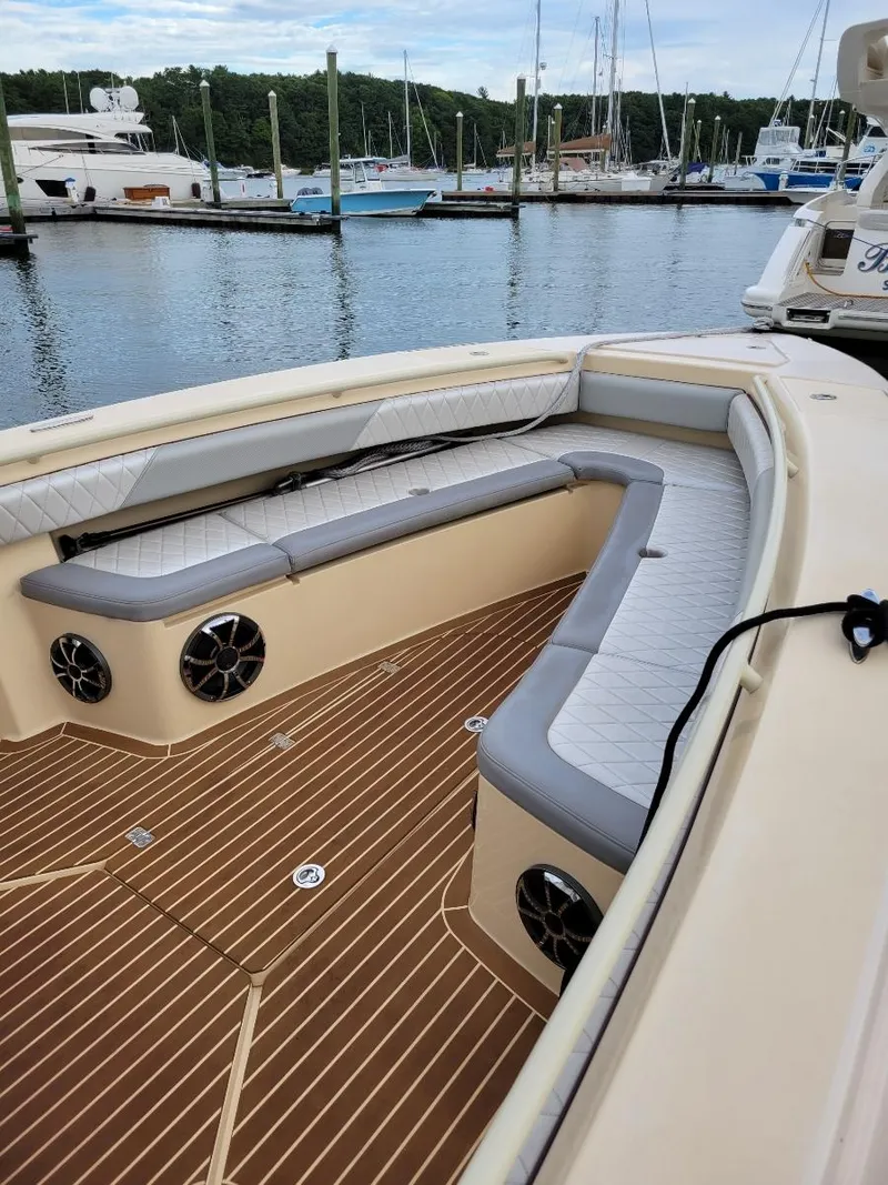 Slide: The Image of 2013 Statement 38 SUV Open boat with spacious seating at a marina. - 1