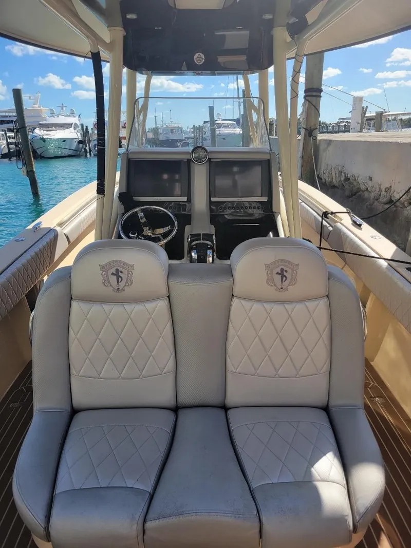Slide: The Image of 2013 Statement 38 SUV Open boat interior with dual seats and dashboard, docked at marina. - 3