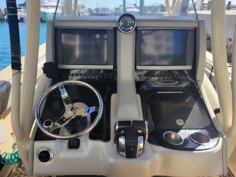 Slide: The Image of 2013 Statement 38 SUV Open boat dashboard with dual screens and steering wheel. - 7