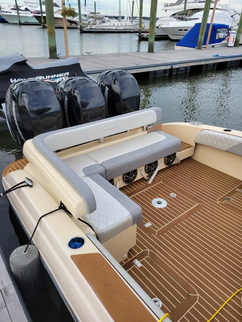 Slide: The Image of 2013 Statement 38 SUV Open boat with triple outboard engines docked at a marina. - 9