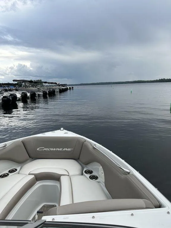 Slide: The Image of 2020 Crownline 215 SS boat on calm lake near dock. - 3