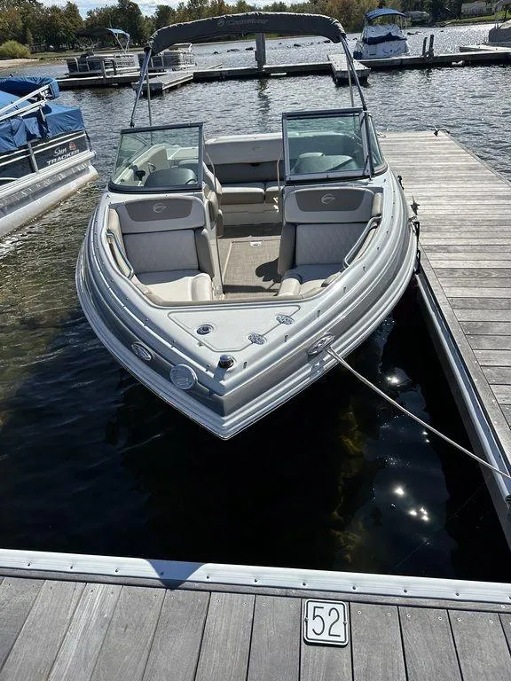 Slide: The Image of 2020 Crownline 215 SS boat docked at a marina. - 4