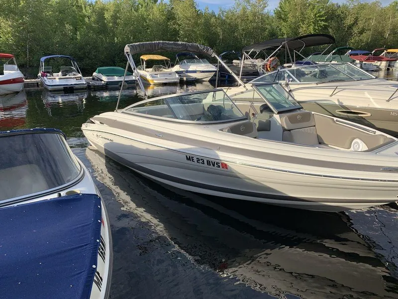 Slide: The Image of 2020 Crownline 215 SS boat docked among other boats. - 5