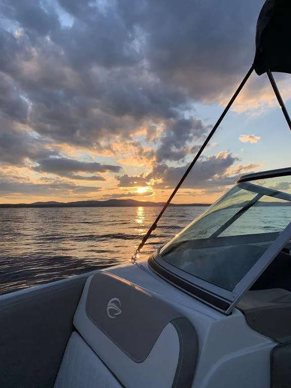 Slide: The Image of 2020 Crownline 215 SS boat on a lake at sunset with dramatic clouds. - 6