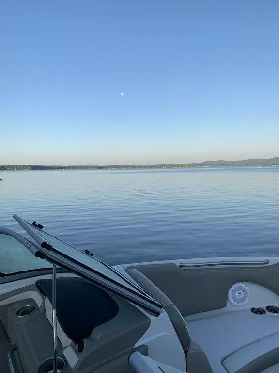 Slide: The Image of 2020 Crownline 215 SS boat on a serene lake at sunset. - 7