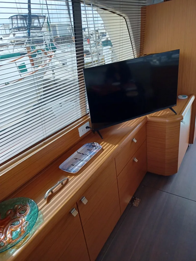 Slide: The Image of Interior of 2020 Greenline 40 yacht with TV and wooden cabinetry. - 13