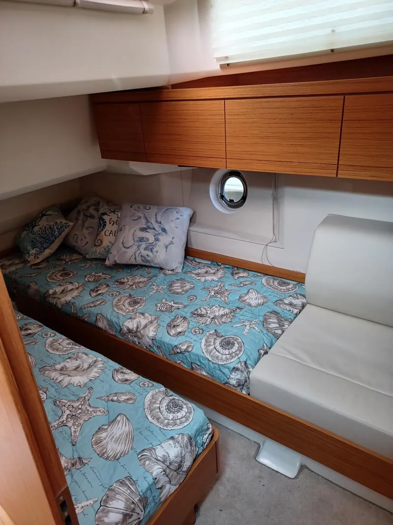 Slide: The Image of Cozy cabin interior of 2020 Greenline 40 yacht with nautical-themed bedding. - 17
