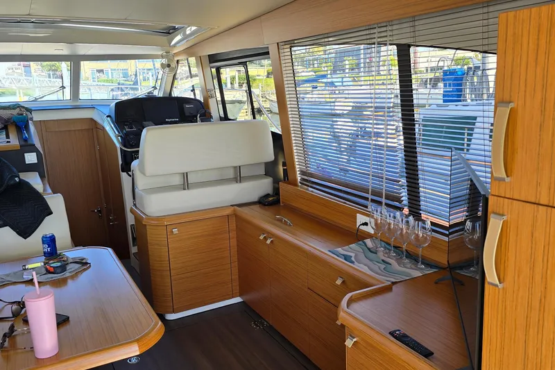 Slide: The Image of Interior of a 2020 Greenline 40 yacht with wooden cabinetry and large windows. - 8