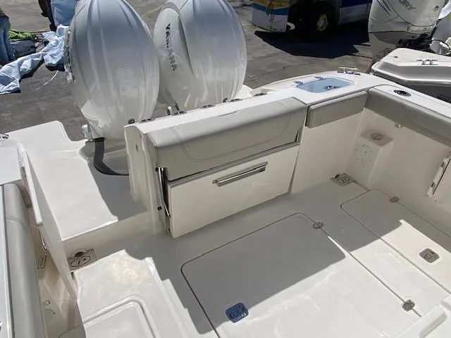Slide: The Image of 2024 Pursuit S 268 boat interior with twin outboard engines. - 11