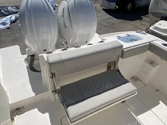 Slide: The Image of 2024 Pursuit S 268 boat with dual outboard engines and foldable seating. - 12