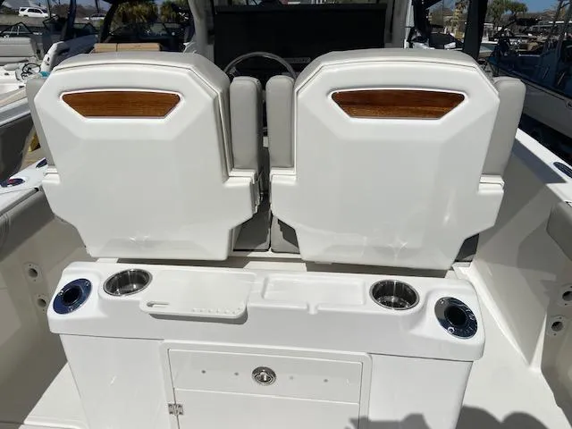 Slide: The Image of 2024 Pursuit S 268 boat interior with dual seats and cup holders. - 14