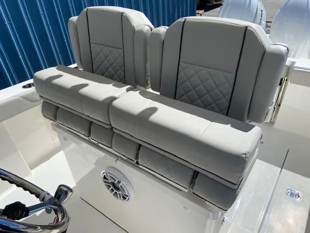 Slide: The Image of 2024 Pursuit S 268 boat with cushioned seating and steering wheel. - 15