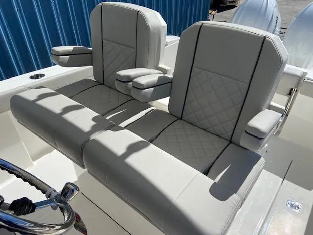 Slide: The Image of 2024 Pursuit S 268 boat with dual cushioned seats and armrests. - 16