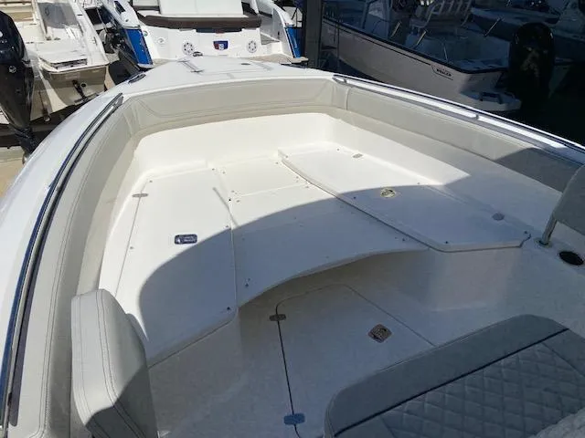 Slide: The Image of 2024 Pursuit S 268 boat interior with spacious seating and storage compartments. - 19