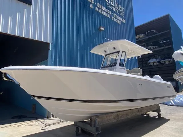 Slide: The Image of 2024 Pursuit S 268 boat docked at a marina storage facility. - 2